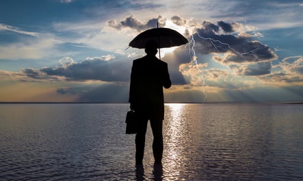 man holding a umbrella and a suitcase