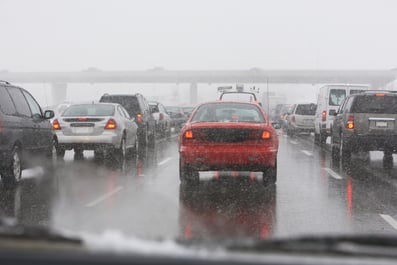 Snow coming down on a busy road in Chicago