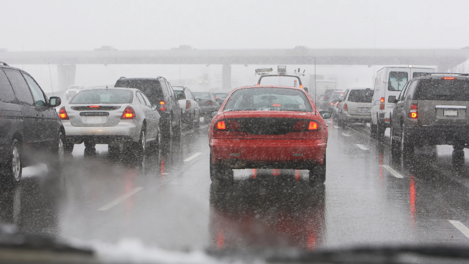 Snow coming down on a busy road in Chicago