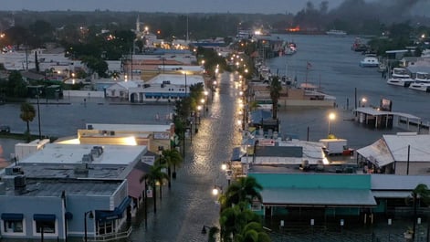 TARPON SPRINGS, FLORIDA - AUGUST 30: In an aerial view, a fire is seen as flood waters inundate the downtown area after Hurricane Idalia passed offshore on August 30, 2023 in Tarpon Springs, Florida. Hurricane Idalia is hitting the Big Bend area of Florida. (Photo by Joe Raedle/Getty Images)