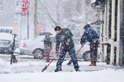 People clear a sidewalk during a winter snow storm in Philadelphia, Tuesday, Feb. 13, 2024. Parts of the Northeast were hit Tuesday by a snowstorm that canceled flights and schools and prompted warnings for people to stay off the roads. (AP Photo/Matt Rourke)