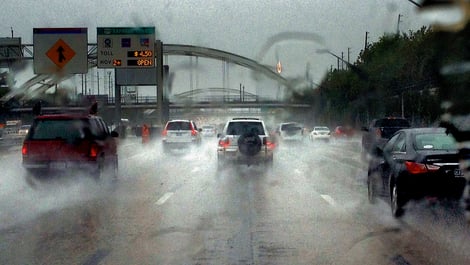 Drivers traveling in rain on busy highway 