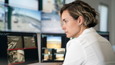 Woman looking at screens during a security operation center