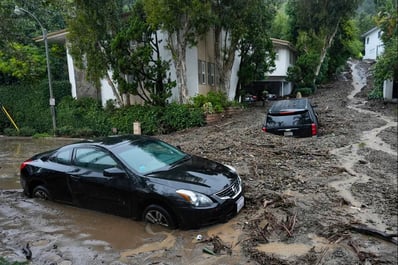 Vehicles are damaged by a mudslide, Monday, Feb. 5, 2024, in the Beverly Crest area of Los Angeles. (AP Photo/Marcio Jose Sanchez)