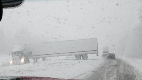 jackknifed truck on snow covered highway