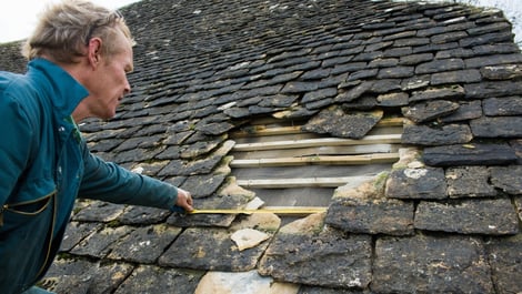 Roofer measuring damage