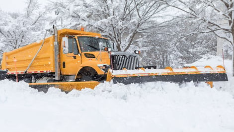 Snow plow removing snow from the road