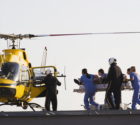Hospital workers rushing a patient onto a mediflight